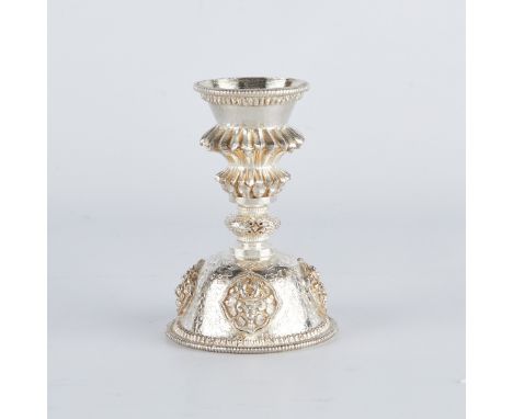 Tibetan sterling silver butter lamp with a stepped stem and finely engraved floral and scrolling designs, for use in Buddhist