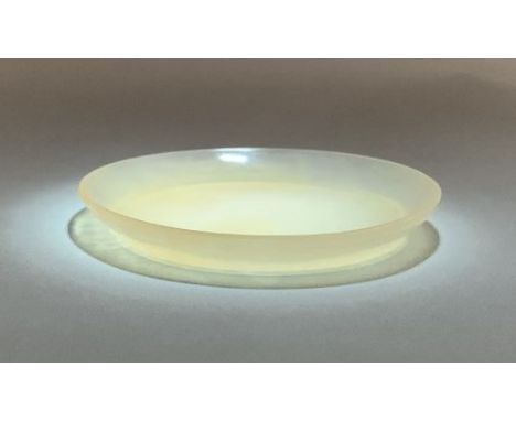 A Chinese off white jade dish, probably late Qing Dynasty or Republican Period, of plain form with a flared foot, 78 mm, diam