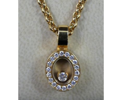 A Chopard Happy Diamond pendant, the oval design, featuring loose diamond to centre, surrounded by a border of eighteen diamo