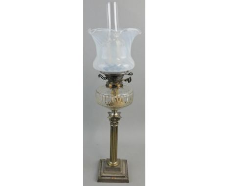 A Victorian electroplated paraffin oil lamp, the opaline glass shade to a clear glass chimney mounted on a Youngs patent plat