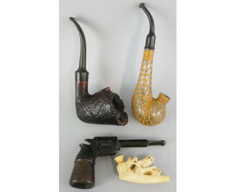 A briar pipe, in the form of a shell, signed Astleys, 109 Jermyn St, London, a novelty pipe in the form of a pistol, a glass 
