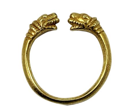 A gold Viking style torque ring, unmarked, with mythological animal head terminals, size R, weight 6.5 gms.