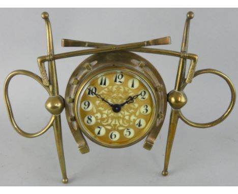 Of equestrian interest, a Victorian novelty brass mantle clock, the pierced dial with Arabic numerals, the case with riding c