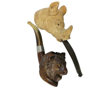 A Meerschaum pipe, the bowl depicting a rhinoceros with glass eyes, 15 cm together a briar pipe with horn mouthpiece, the bow