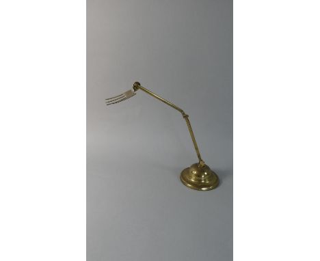 A Jointed Brass Toasting Fork with Iron Weighted Base, Inscribed Y S C Toastee, 37cm High 
