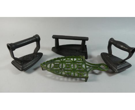 A Collection of Three Vintage Flat Irons and a Stand 