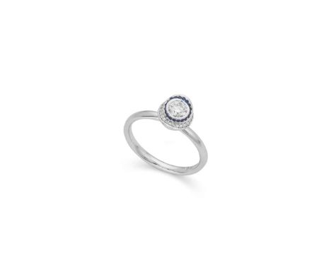  † A 18ct white gold sapphire and diamond dress ring  Collet-set with a round brilliant-cut diamond, in a border of round-cut
