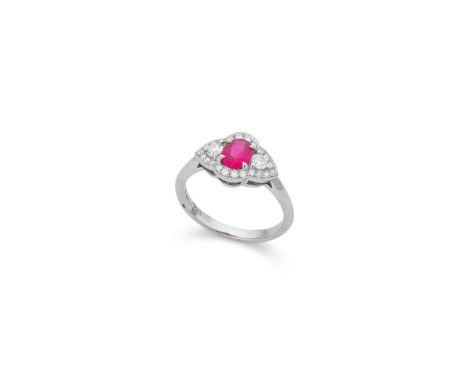  † A platinum ruby and diamond cluster ring  Claw-set with an oval-cut ruby in a border of graduated round brilliant-cut diam