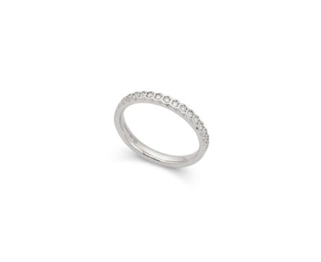  † A platinum diamond half-eternity ring  Collet-set with seventeen round brilliant-cut diamonds, UK hallmarks Ring size: M  