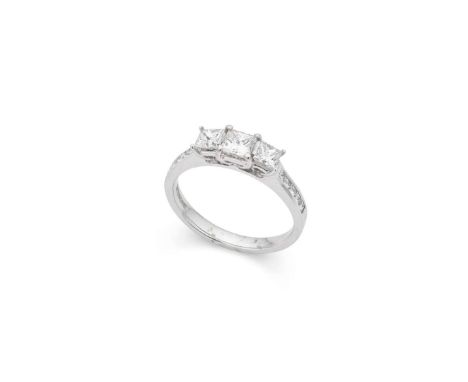  † An 18ct white gold diamond three-stone ring  Claw-set with three princess-cut diamonds, each shoulder channel-set with fiv