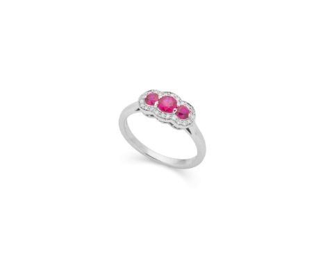  † A platinum ruby and diamond cluster ring  Claw-set with three graduated round-cut rubies, in a border of small round brill
