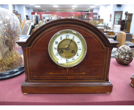 An Edwardian Inlaid Mahogany Mantel Clock, with brass dial, white enamel chapter ring with Roman numerals, on brass bun feet.