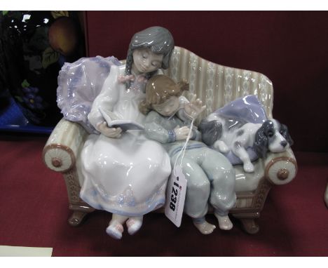 A Lladro Figure Group "Big Sister", with two children and dog seated on a sofa reading a book at bedtime, impressed No. 5735,