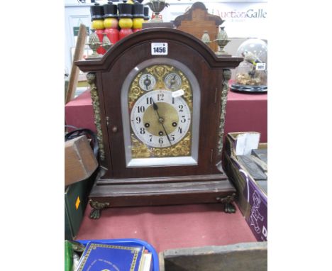 A XX Century Westminster Chimes Bracket Clock, with pineapple finials, arched top, stepped base, on cast paw feet, brass dial