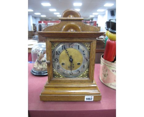 An Oak Cased Eight-Day Mantel Clock, silvered chapter ring with Arabic numerals, with key.