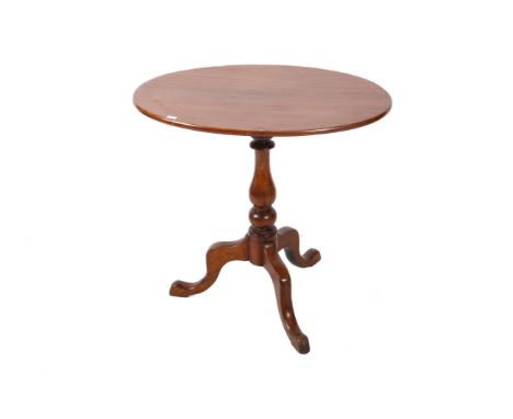 A 20th century wooden side table. The oval top mounted onto a turned baluster column and tripod base, H67cm x W69cm x D49cm