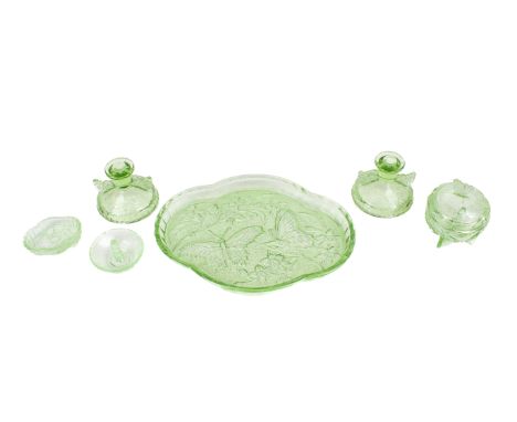 A vintage green glass dressing table set. Comprising a large tray, a pair of candlesticks, a lidded pot and two small dishes,