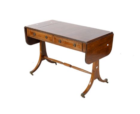 A 20th century walnut veneer Regency style sofa table. Having drop leaf ends, two lower drawers and a turned stretcher raised