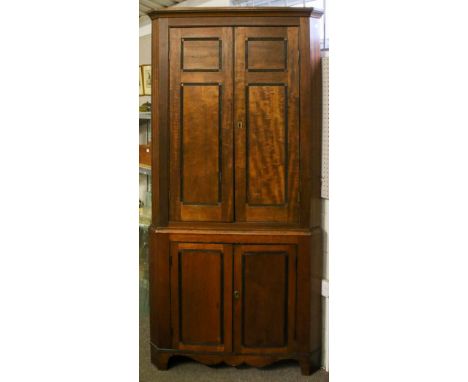 A late Victorian mahogany two piece corner cabinet. Upper section having three fixed and shaped shelves painted light green, 
