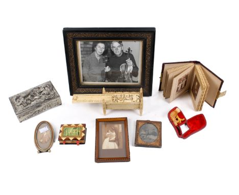 An assortment of collectables. Including two picture frames, a carved pipe with an amber mouthpiece, a set of dominoes, a pho