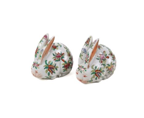 A pair of 20th century Chinese pottery figures modelled as rabbits. Decorated with peaches and other flora. Painted mark to b