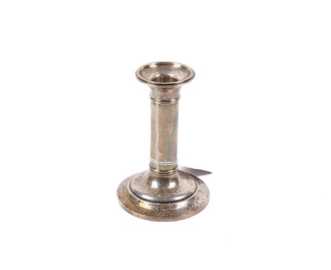 An early 20th century small silver weighted candlestick. Of columnar form with spread, stepped foot, hallmarks for Williams (