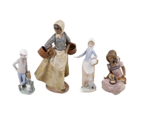 Four Nao ceramic figures. Two modelled as women holding baskets, one of a boy beside a tree stump and one of a girl feeding c