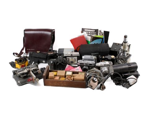 A collection of assorted vintage film cameras and accessories. Including a microscope, video and cine-cameras, etc. 