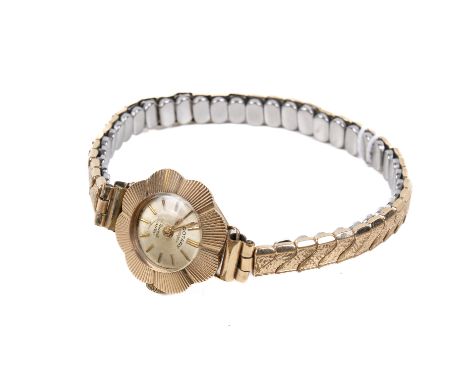 A mid-century 9ct gold cased Rotary wristwatch. With gift hour markers to a champagne face with a flower shaped frame, the in