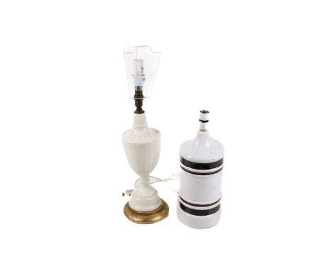 Two 20th century ceramic table lamps. Consisting of an urn-shaped cream coloured lamp base raised on a gilt wood base, H40cm,