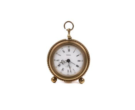 A vintage Swiza table alarm clock. The white dial having Roman numerals and Arabic second markers, within a moulded brass cas