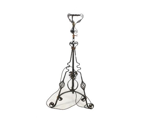 A cast metal adjustable standard lamp. Having copper brackets and handle, with scroll and floral details, on a tripod base, H