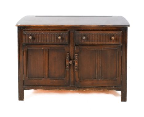 A vintage Ercol sideboard. Having two drawers over a two door cupboard. H90cm x W126cm x D50cm