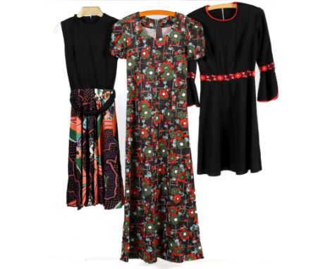 A collection of vintage dresses. Comprising a Fiona sleeveless dress, having a scoop neckline, black top and patterned skirt,