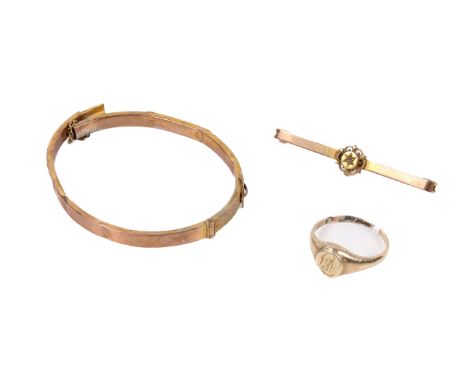 A yellow metal signet ring, bar brooch and a 9ct gold bangle. The signet ring engraved with a monogram and marked '9ct', size