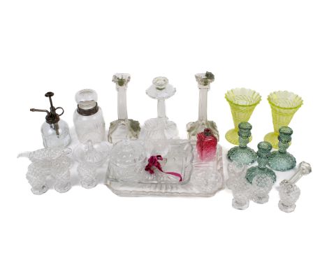 A collection of assorted vintage glassware. Including a pair of candlesticks, trays and a pair of yellow vases, etc. 