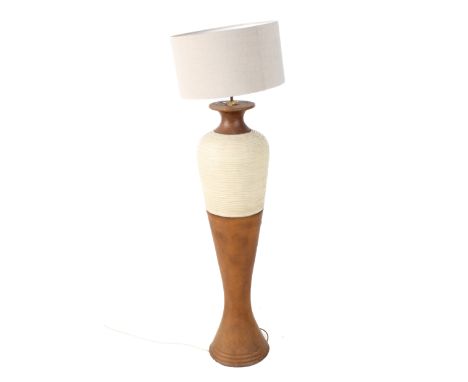 A 20th century large pottery lamp and shade. The baluster form lamp glazed brown with a cream textured band, topped with a gr