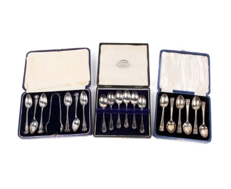 Three sets of Art Nouveau and later silver teaspoons and a pair of sugar tongs. Comprising one set with matching sugar tongs,