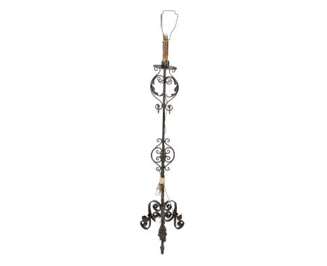 A late 19th/early 20th century wrought iron standard lamp. Converted from a candlestick, with tripod base. H130cm