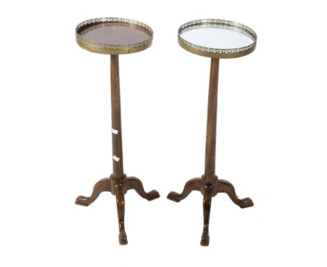 A pair of early 20th century jardiniere stands. The circular tops having pierced brass galleries, mounted on a turned and tap