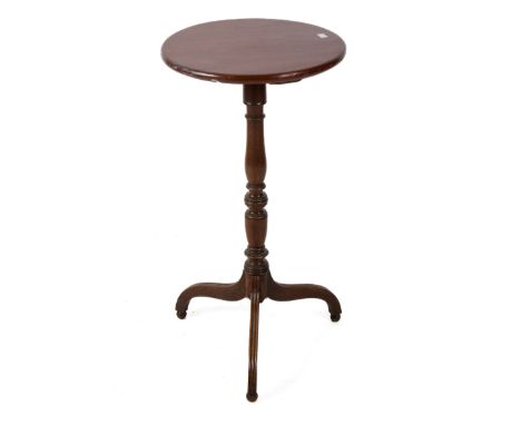 A 20th century mahogany wine table. The circular top mounted on a turned column and tripod base with reeded supports, H77.5cm