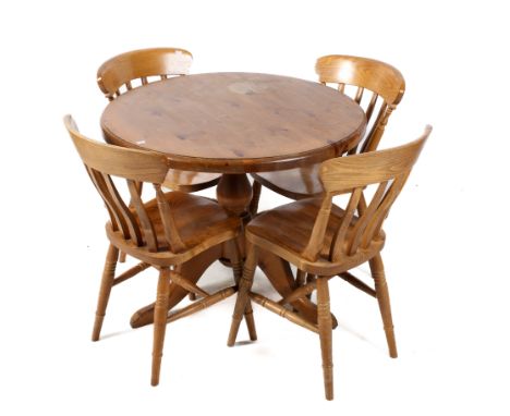 A contemporary circular pine kitchen table and four matching chairs. Raised on a tripod base. diameter 87cm