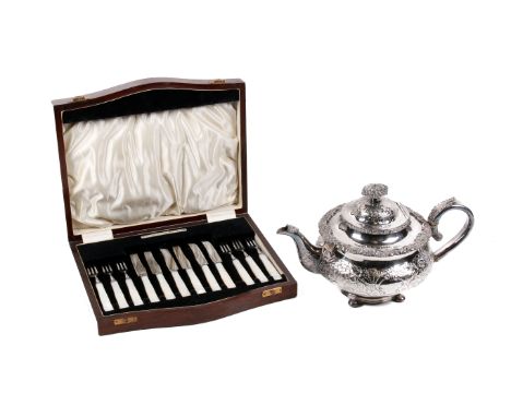 A vintage silverplated teapot and a boxed set of fruit knives and forks. The teapot with dense flower decoration, the knives 