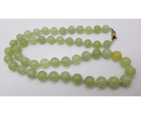 A string of jade beads with silver clasp