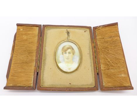 A portrait miniature on ivory in a tooled leather case, a/f
