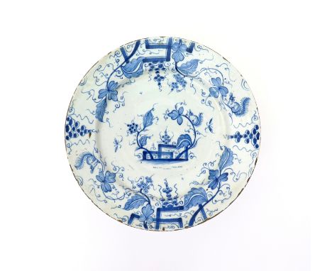 A large English delftware charger  c.1740, painted in blue with squirrels scampering amongst branches of fruiting grapevine i