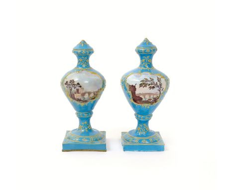 A matched pair of Birmingham enamel urn-shaped vases  c.1775, painted with scenes of fishermen on a riverbank before an arche