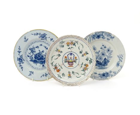 Three delftware plates  18th century, two painted in blue with Oriental flowers, the last in polychrome enamels with a censer