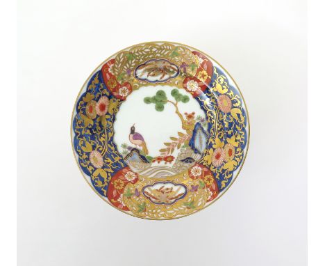 A Meissen plate  c.1740, richly decorated in the Imari palette with a bird perched on rockwork beneath a pine tree issuing fr