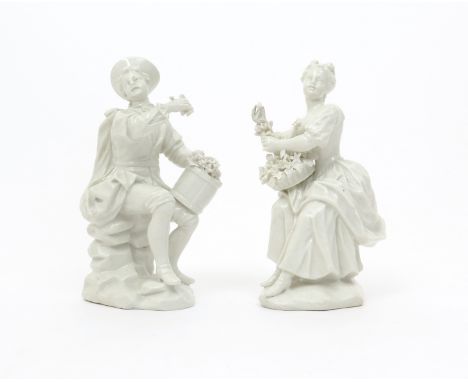 A pair of French soft-paste porcelain figures  mid 18th century, modelled as a vintner and his companion, each seated on a ro